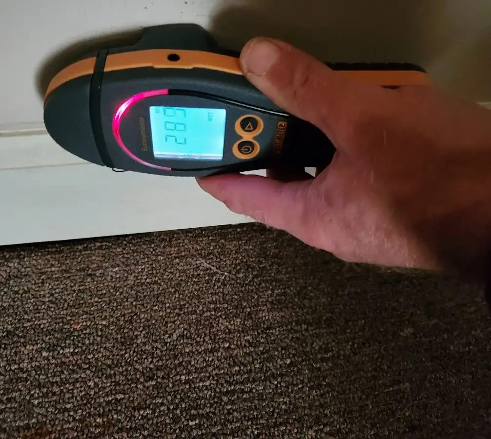 Moisture detection at baseboard during Storm Damage Restoration in Northlake